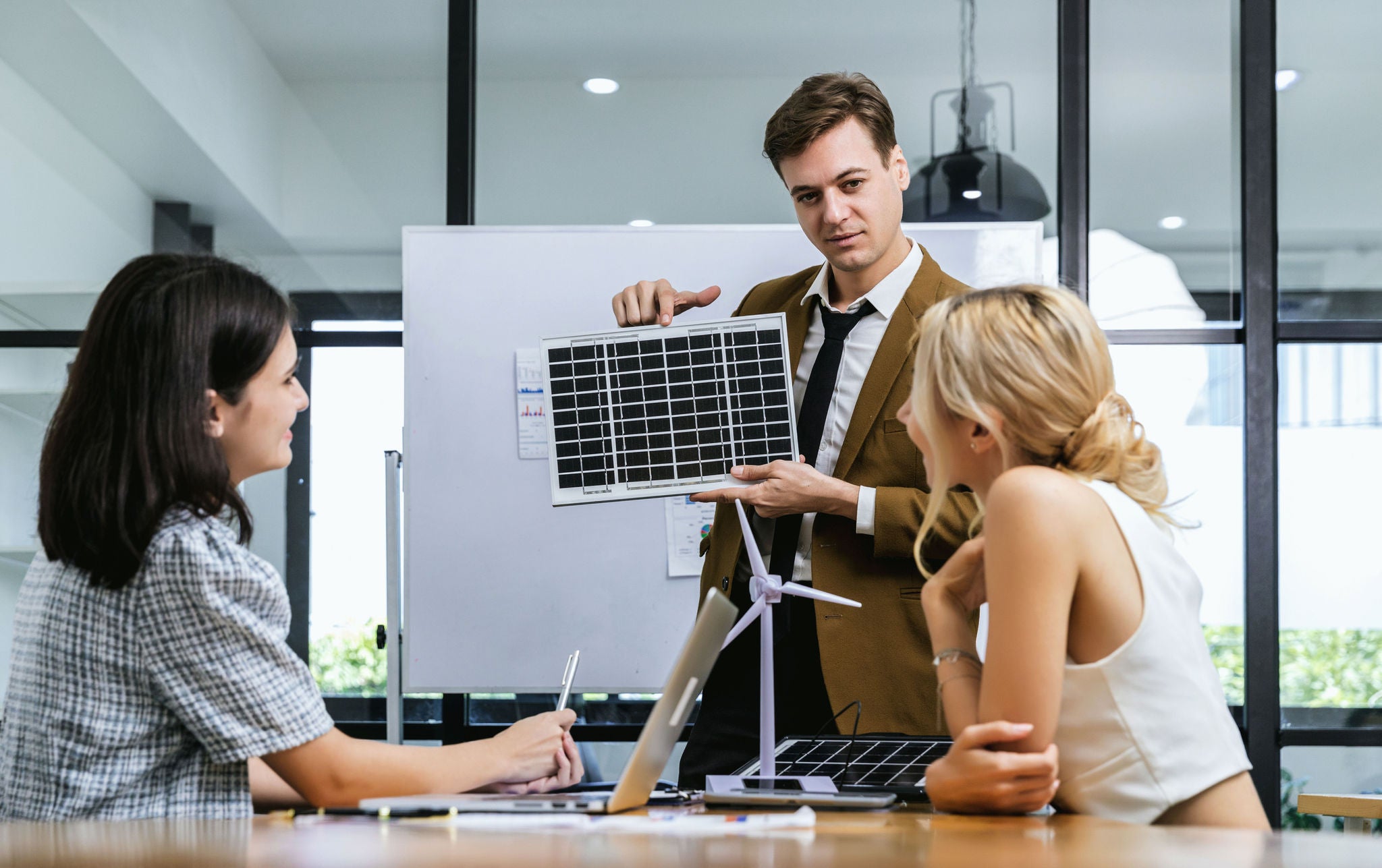 Business person meeting on solar cell panel technology. Business People Discussing Solar Power Environment Concept